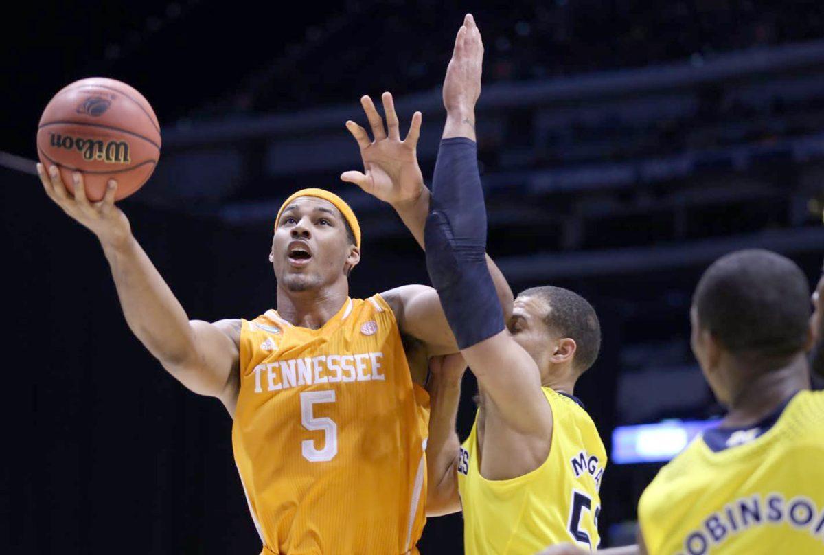 Junior forward Jarnell Stokes drives past Michigan's Jordan Morgan during UT's 73-71 loss in the Sweet 16 in Indianapolis on March 28. Stokes decided to forgo his senior season and declare for the NBA Draft on Friday.