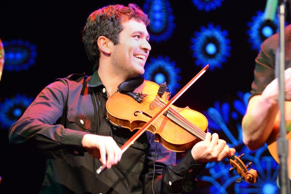 Mike Barnett, violinist of the Deadly Gentlemen, enjoys the atmosphere while playing at the Bijou Theatre on Wednesday.