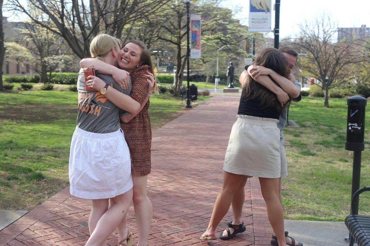 SGA president Kelsey Keny, left, and SGA vice president Connor Dugosh, right, hug their supports after hearing the results of the campaign on Thursday at Circle Park.