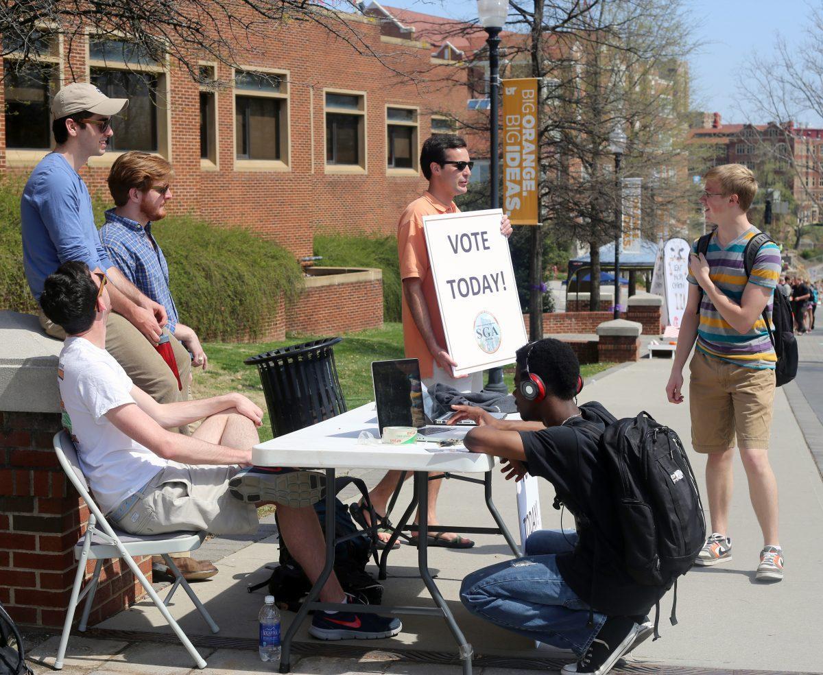 SGA President Jake Baker, back center, and other members of student government encourage students on Pedestrian Walkway to vote in this year's SGA elections on Wednesday. Voting for campaigns went live online at votesga.utk.edu on Wednesday and runs until today at 5 p.m.