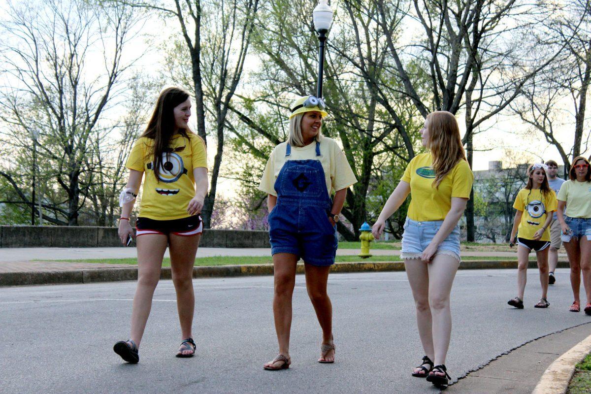 Students dressed as minions from the movie "Despicable Me" walk around Circle Park during Friday's Relay for Life event, which was under the theme "When You Wish Upon A Cure."