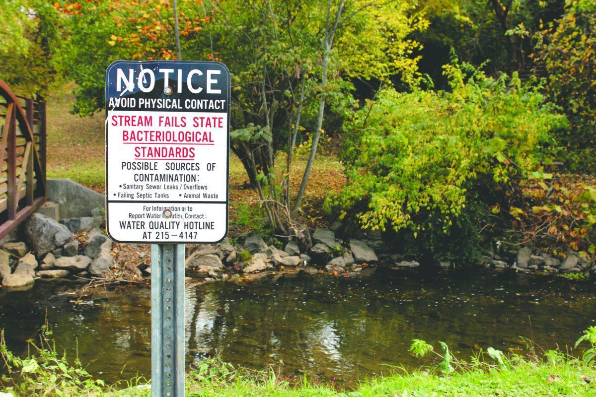 A sign warns visitors of the water quality in the Tyson McGhee River behind The Tower at Morgan Hills apartments.