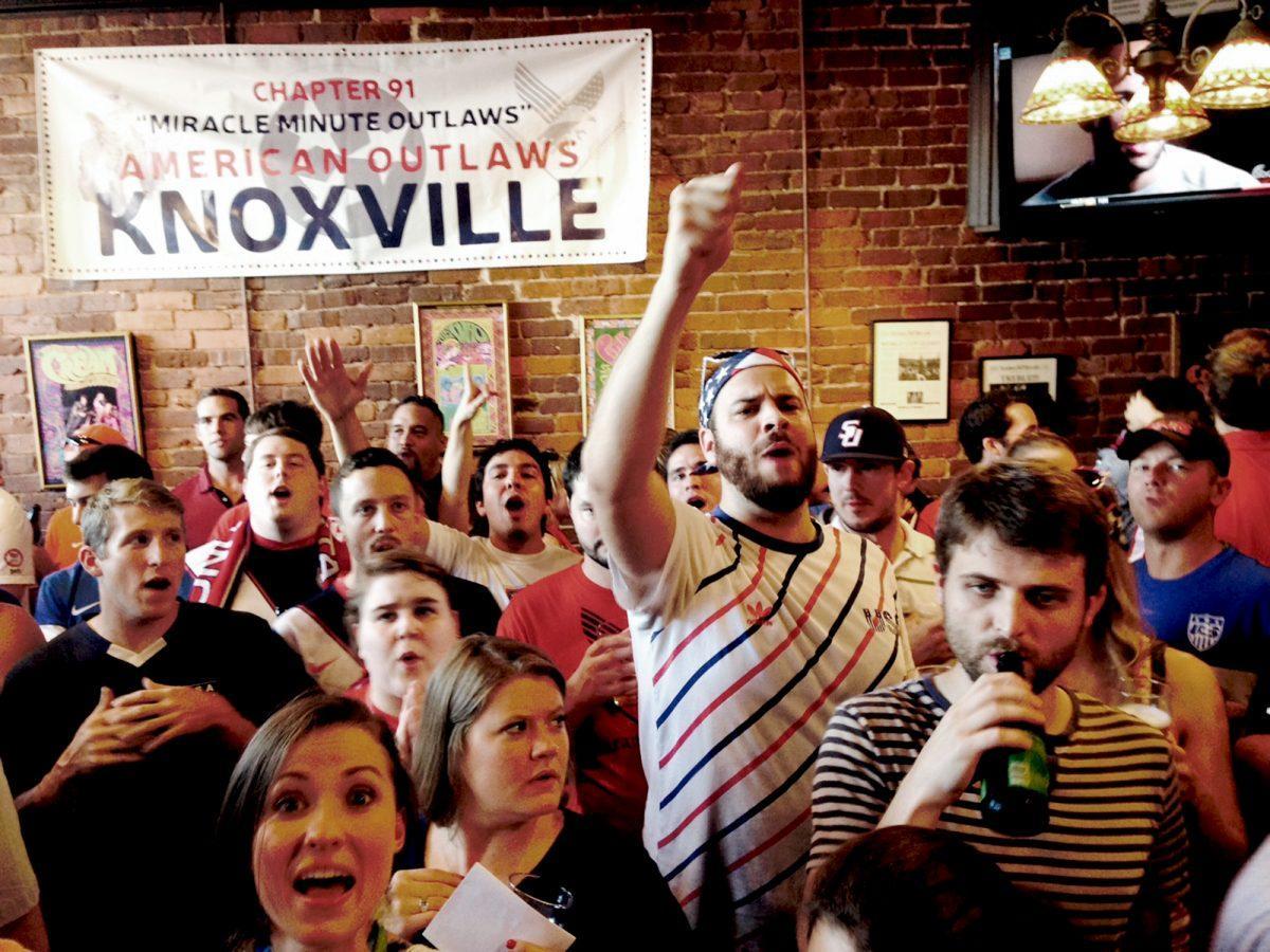A lively crowd of the American Outlaws, a local Knoxville soccer club, join together to watch the US play against Portugal Sunday.