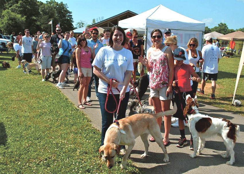 Jennifer Boyle, left, a recent graduate in communication studies, organized the walk in memory of her daughter, Abby. Her dog's name is Bella. On the right is Lauren Clay, Abby's step mom and her dog, Murphy.