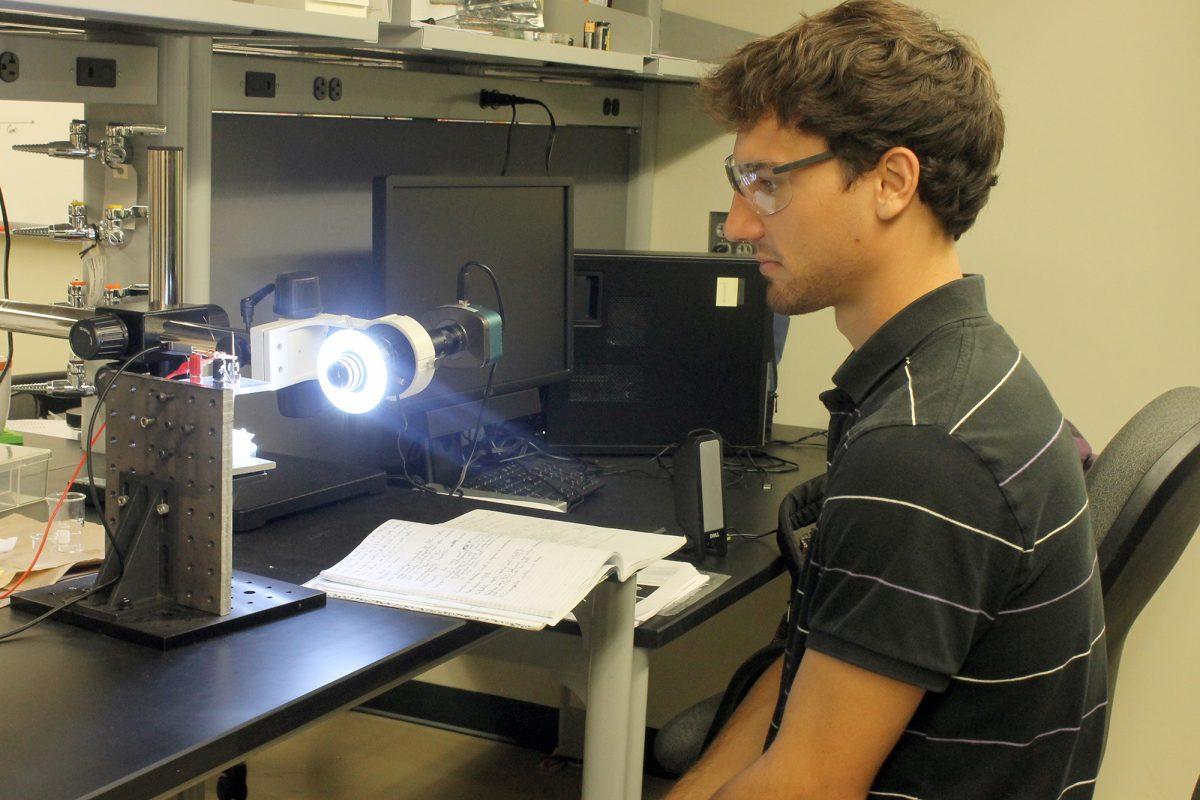 Neil Brown works with a scanning tunneling microscope (STM) tip preparation research in Senter hall lab 116. The tips must be extremely sharp (only a few atoms across the apex), in order to make high resolution measurement.
