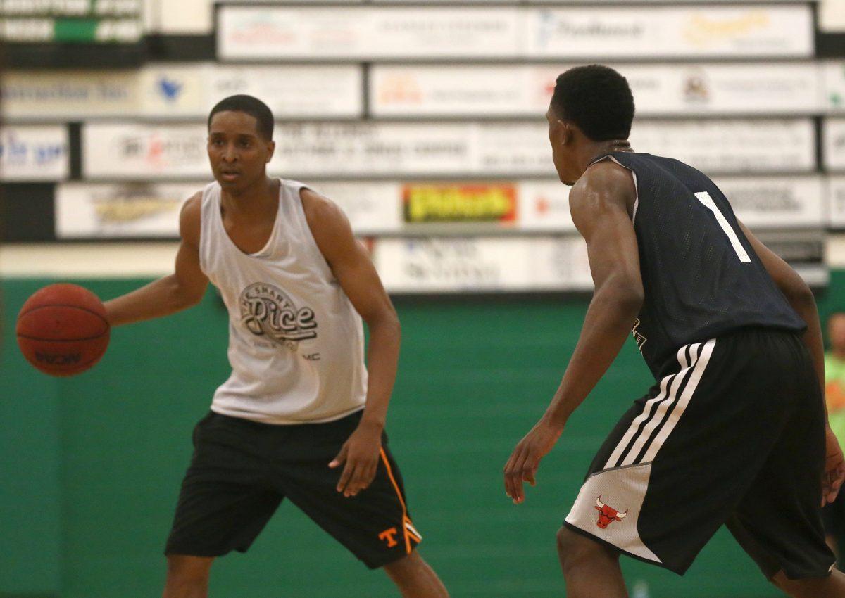 Rising freshman Detrick Mostella goes for the drive around teammate Josh Richardson at the Rocky Top League Championship game at Knoxville Catholic High School on July 2.