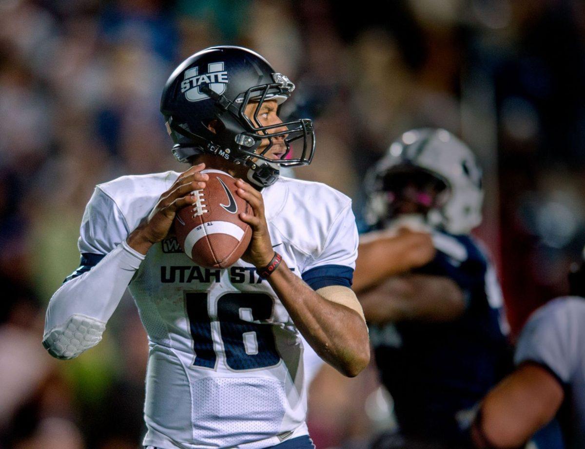 Utah State Chuckie Keeton surveys the defense in the pocket in the Aggies, 31-14, loss to the BYU Cougars on Oct. 4, 2013.