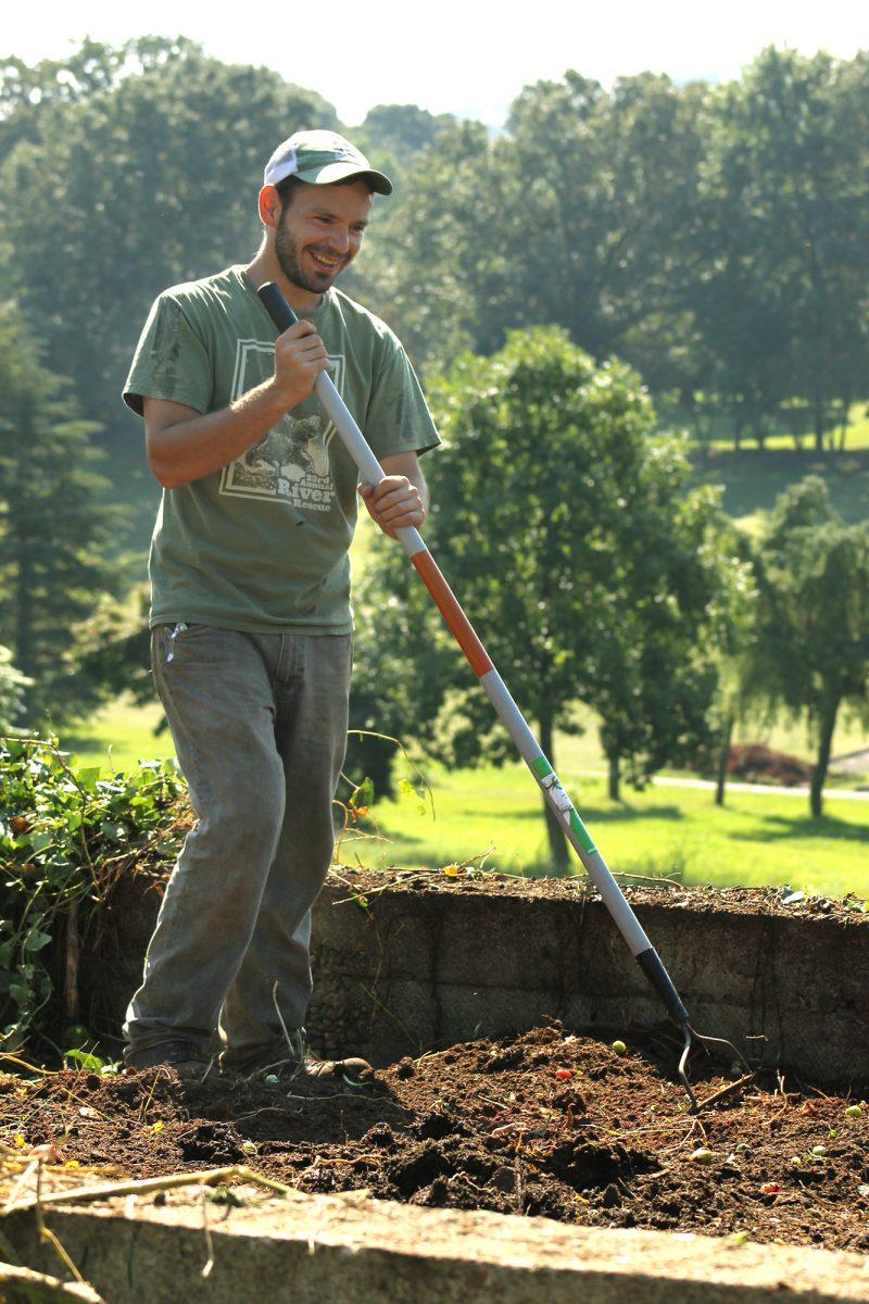 Daniel Aisenbrey, an assistant groundskeeper at the Knoxville Botanical Gardens, lends a hand as volunteers from UT's Ignite Serves work to prepare a plot for the Big Orange Orchard project.