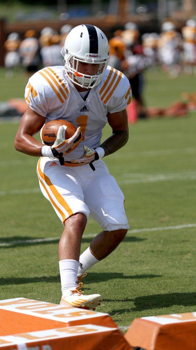 Freshman back Jalen Hurd runs drills at fall football camp on Tuesday, Aug. 5.