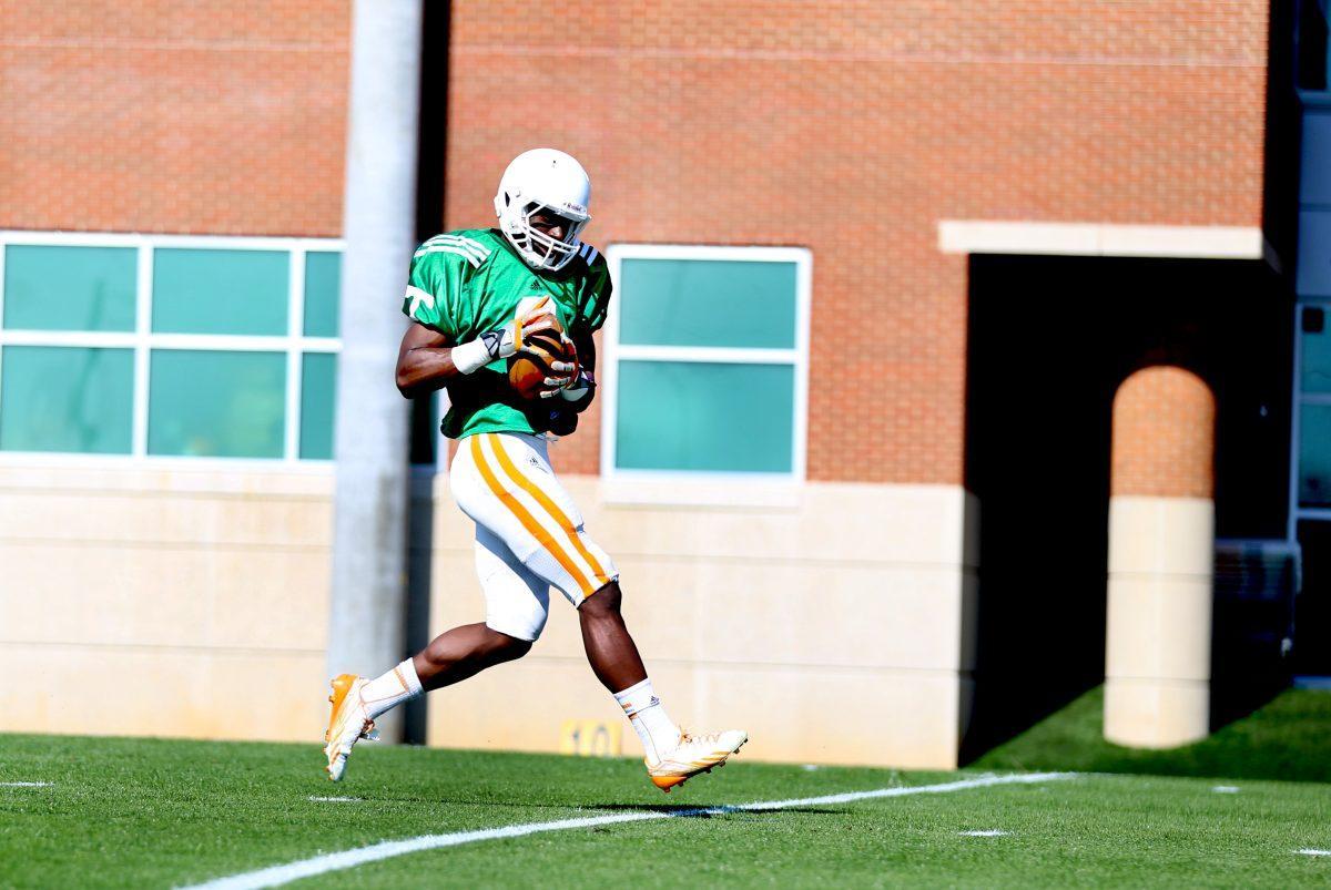 Sophomore wide reciver Marquez North runs drills at spring football practice on April 1, 2014.