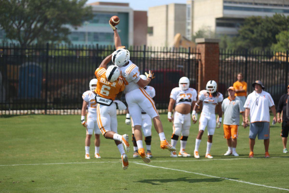 Freshman safety Todd Kelly Jr. blocks Daniel Helm during competition Tuesday at fall football camp on Aug. 5, 2014.