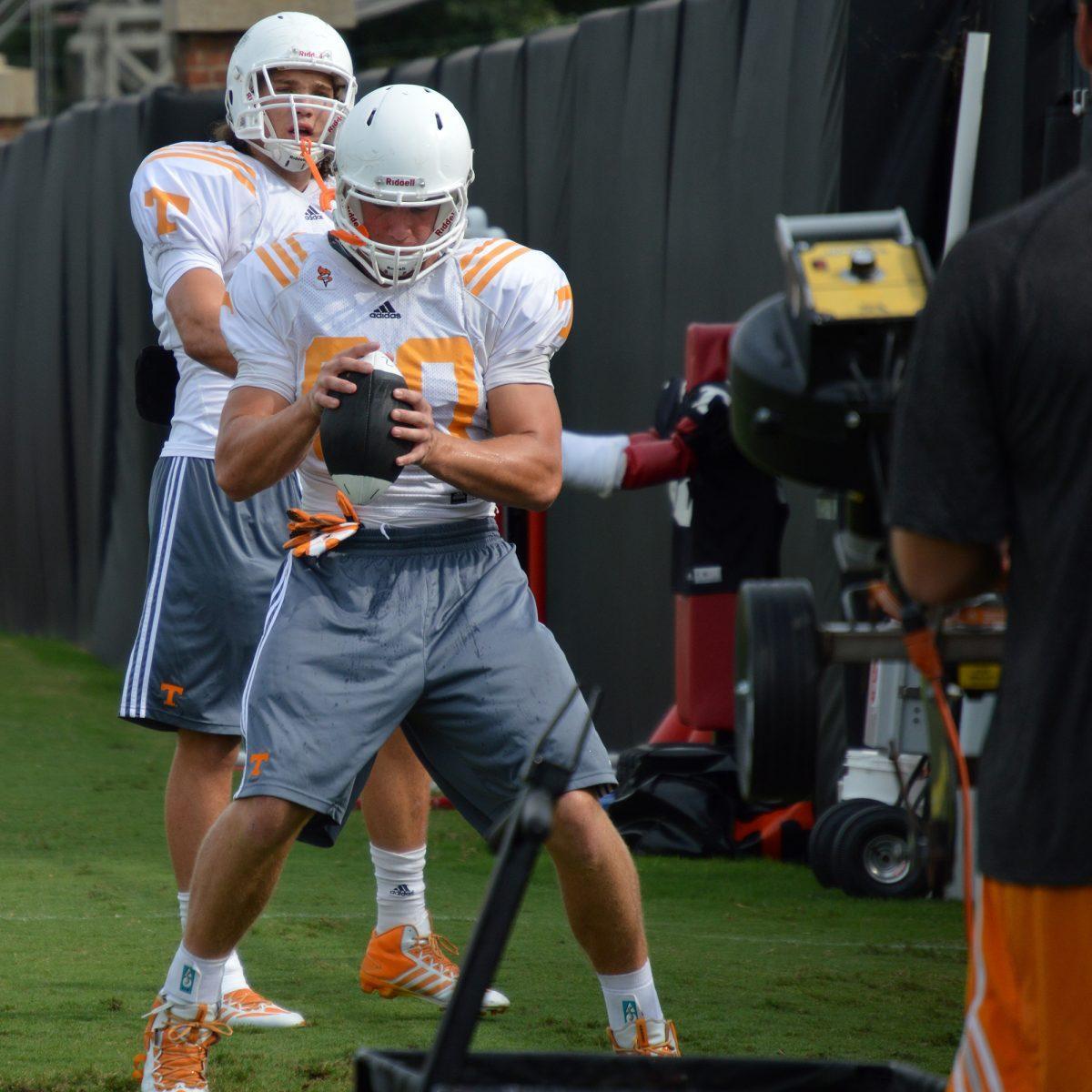 Freshman tight end Daniel Helms catches a ball from a pass machine during practice Sept. 10.