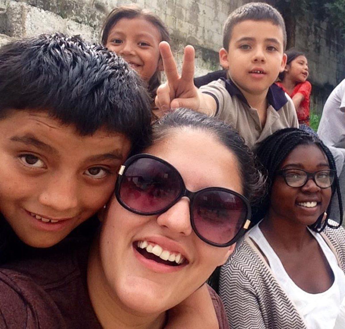 Karen Trevino, center, volunteered in Guatemala City this past summer. "The kids over there are so happy with what they have," Trevino said.