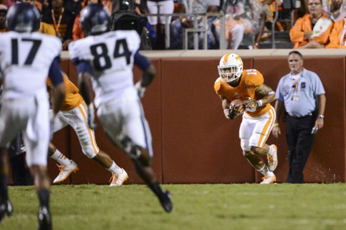 Running back Devrin Young fields and returns a kickoff in the Vols' 38-7 victory over Utah State on Aug. 31.