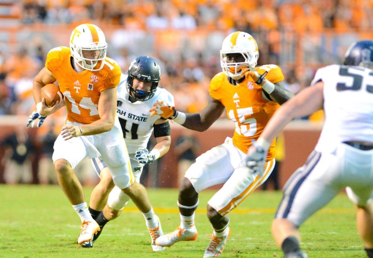 Justin Worley, left, runs past the opposing players with Marlin Lane, right, behind.