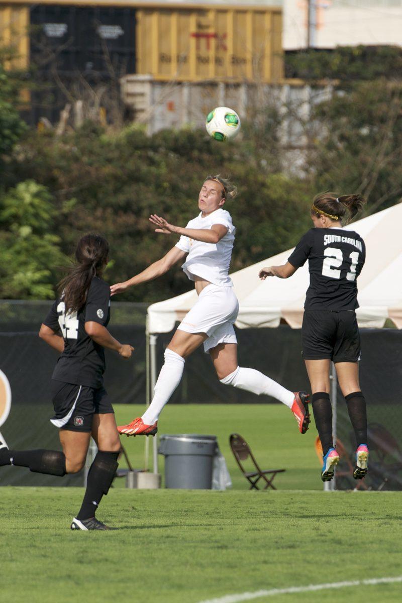 Hannah Wilkinson, center, heads a ball during UT's match against South Carolina on Oct. 6, 2013.