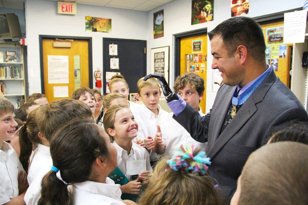 Medal of Honor recipient Leroy Petry shows students his artificial right hand.