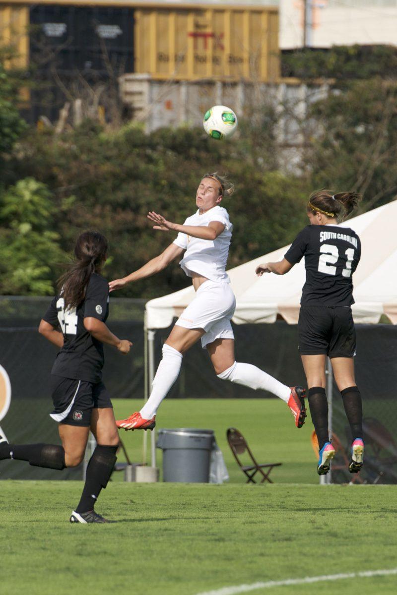 Hannah Wilkinson, center, heads a ball during UT's match against South Carolina on Oct. 6, 2013.