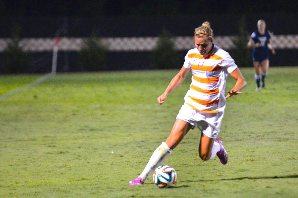 Senior forward Hannah Wilkinson dribbles the ball on the field in a game against BYU on Aug. 29.