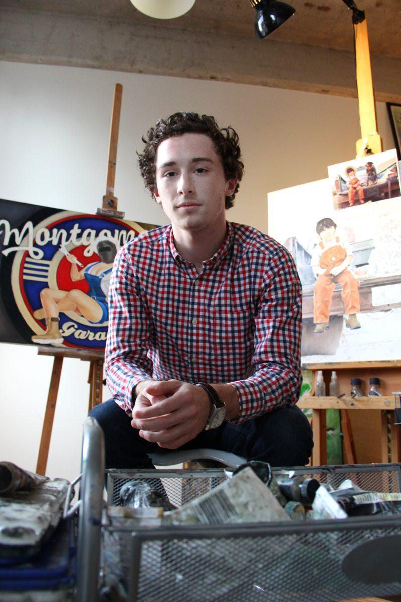 Caden Montgomery, 19-year-old local artist, sits in his studio in the JFG Coffee building downtown.