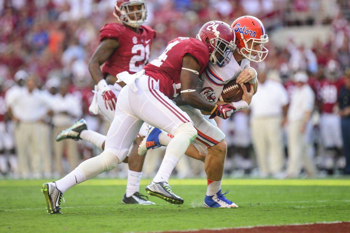 Junior quarterback Jeff Driskel, white, powers toward the goalline in the Gators' 42-21 loss to the Alabama Crimson Tide on Sept. 20.