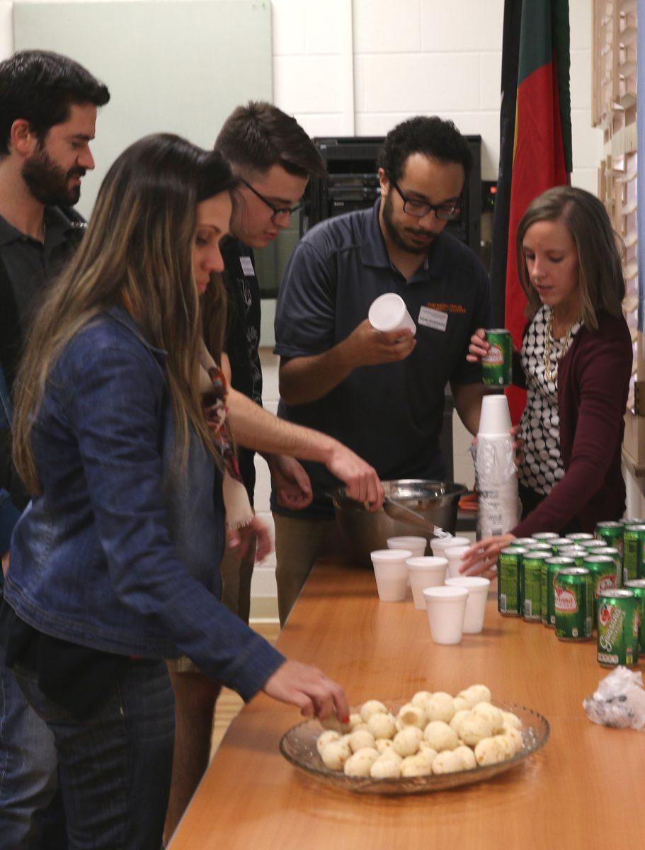 Students sample Brazilian sweets during the coffee house on Monday at the International House.