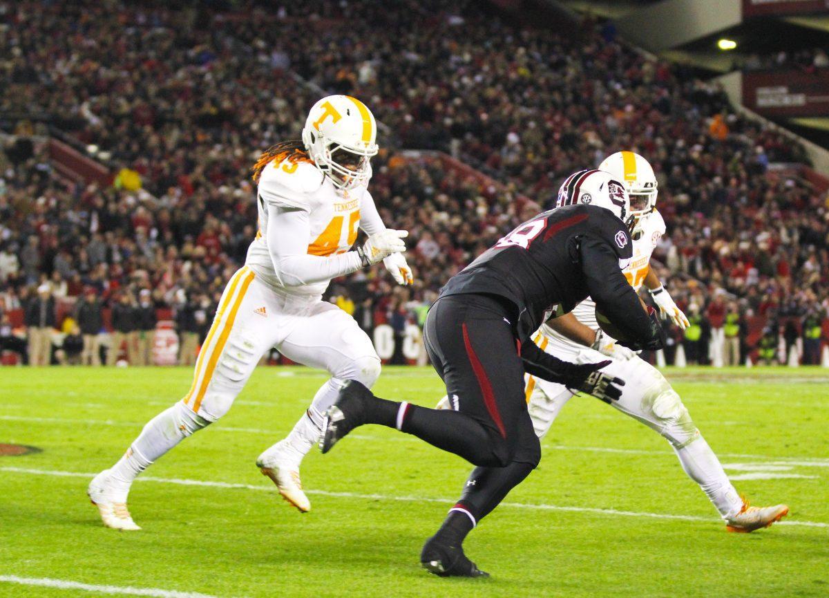 Senior A.J. Johnson attempts to tackle an opponent during the 45-42 victory game against South Carolina.