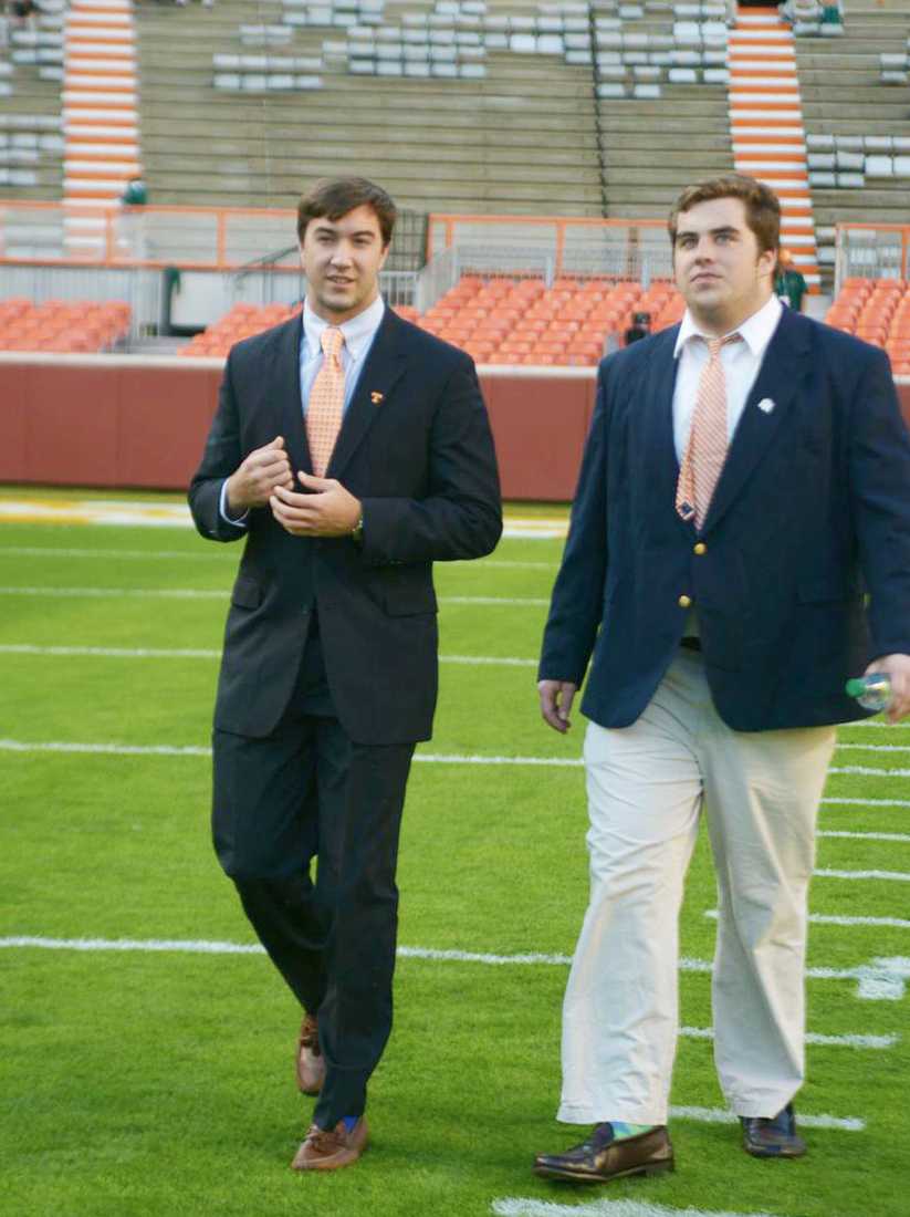 Senior quarterback Justin Worley in a suit while walking the field at Neyland Stadium.