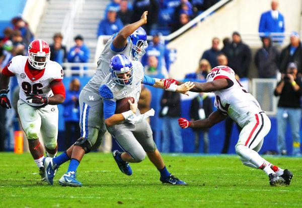 Sophomore quarterback Patrick Towles scurries forward during Kentucky's 63-31 loss to Georgia on Nov. 8