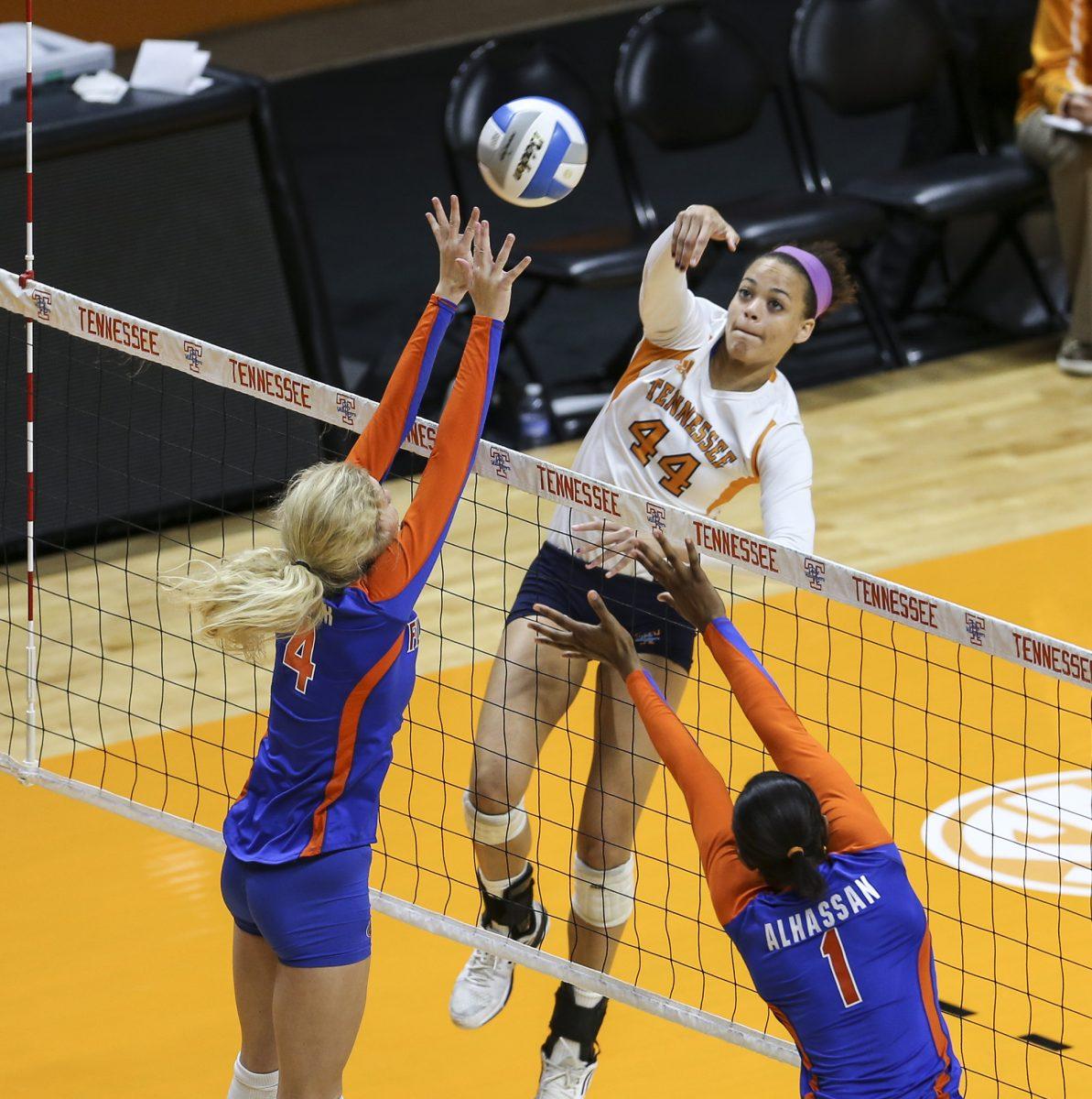 Sophomore hitter Ashley Mariani, center, spikes the ball during the game against Florida on Sunday.
