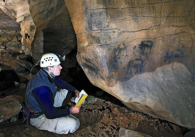 Jan Simek, UT professor of anthropology, looks at cave paintings in a Tennessee cave in 2008.