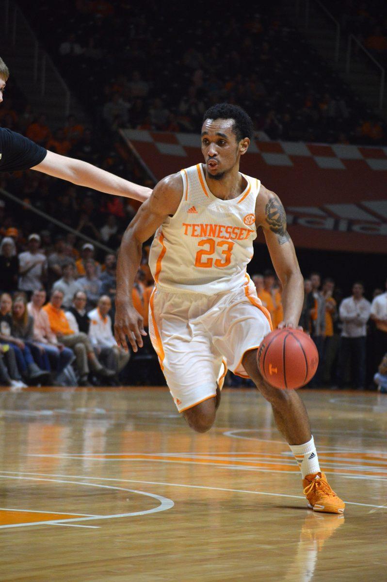 Junior forward Derek Reese dribbles down the court during UT's game against Vanderbilt.