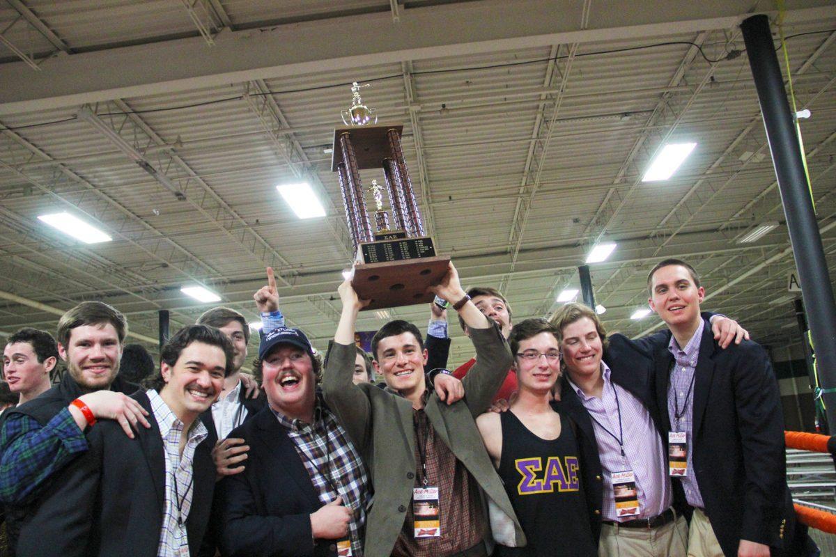 Members of Sigma Alpha Epsilon hold the trophy after Saturday night's rounds of boxing.