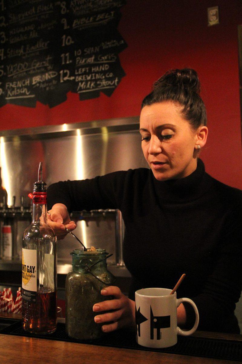 Chrissy Hai, the mind behind the cocktail menu, scoops spiced butter for the Hot Buttered Britches drink
