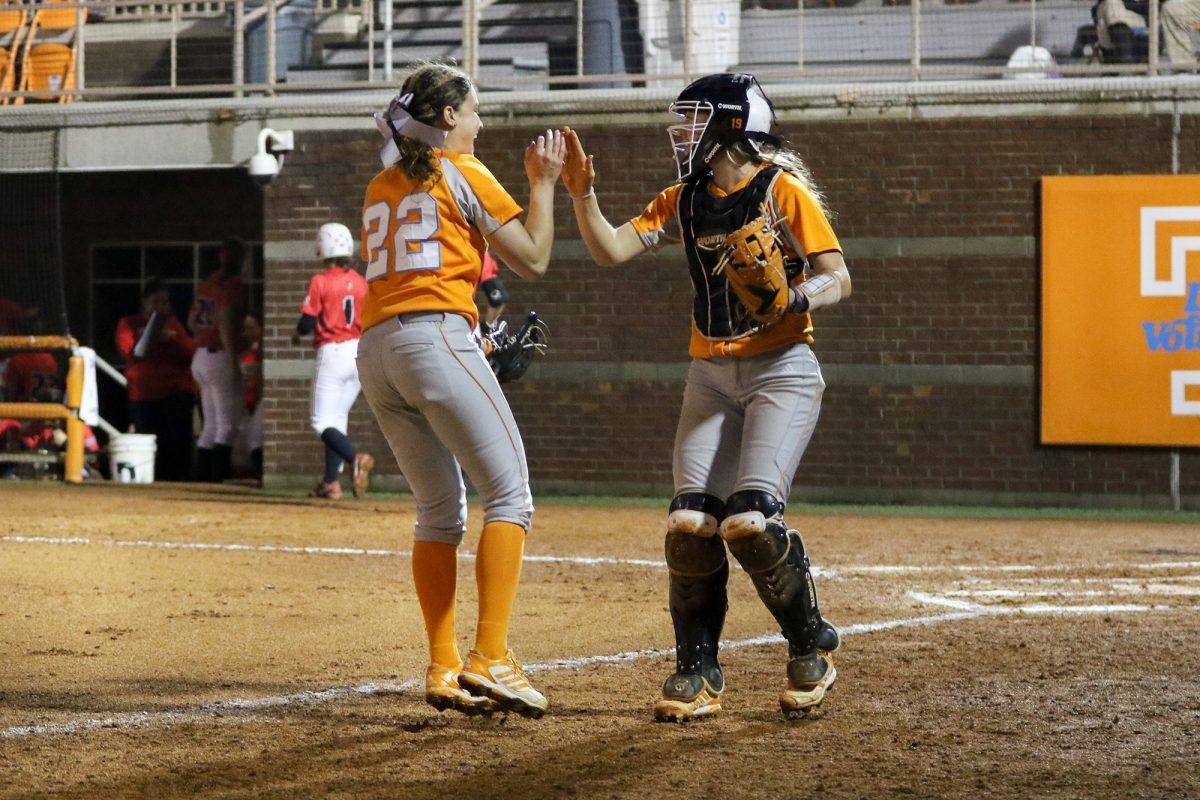 Pitcher Erin Gabriel, left, and catcher Lexi Overstreet, right, high five after Gabriel's no-hitter against Illinois State on March 10.