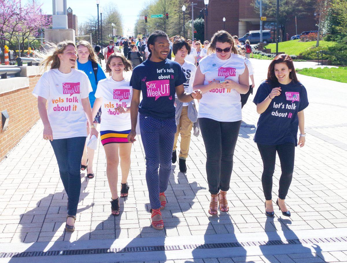 Members of Sex Week and other Hike the Hill in Heels participants walk across the pedestrian bridge to the Hill. The event was a part of Center for Health Education &amp; Wellness's Sexual Assault Awareness Month.