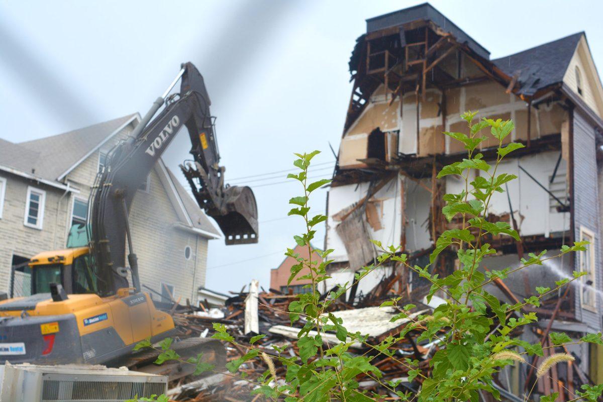 Workers tear down the 301 White Avenue house on Sept. 9, 2015. Located near Vol Hall, the house's style was a typical late Victorian architecture found throughout the Fort Sanders neighborhood.