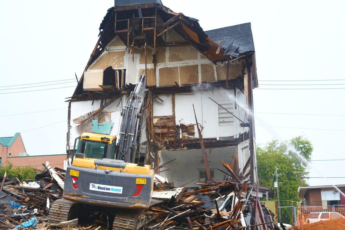 Workers tear down the 301 White Avenue house on Sept. 9, 2015. Located near Vol Hall, the house's style was a typical late Victorian architecture found throughout the Fort Sanders neighborhood.