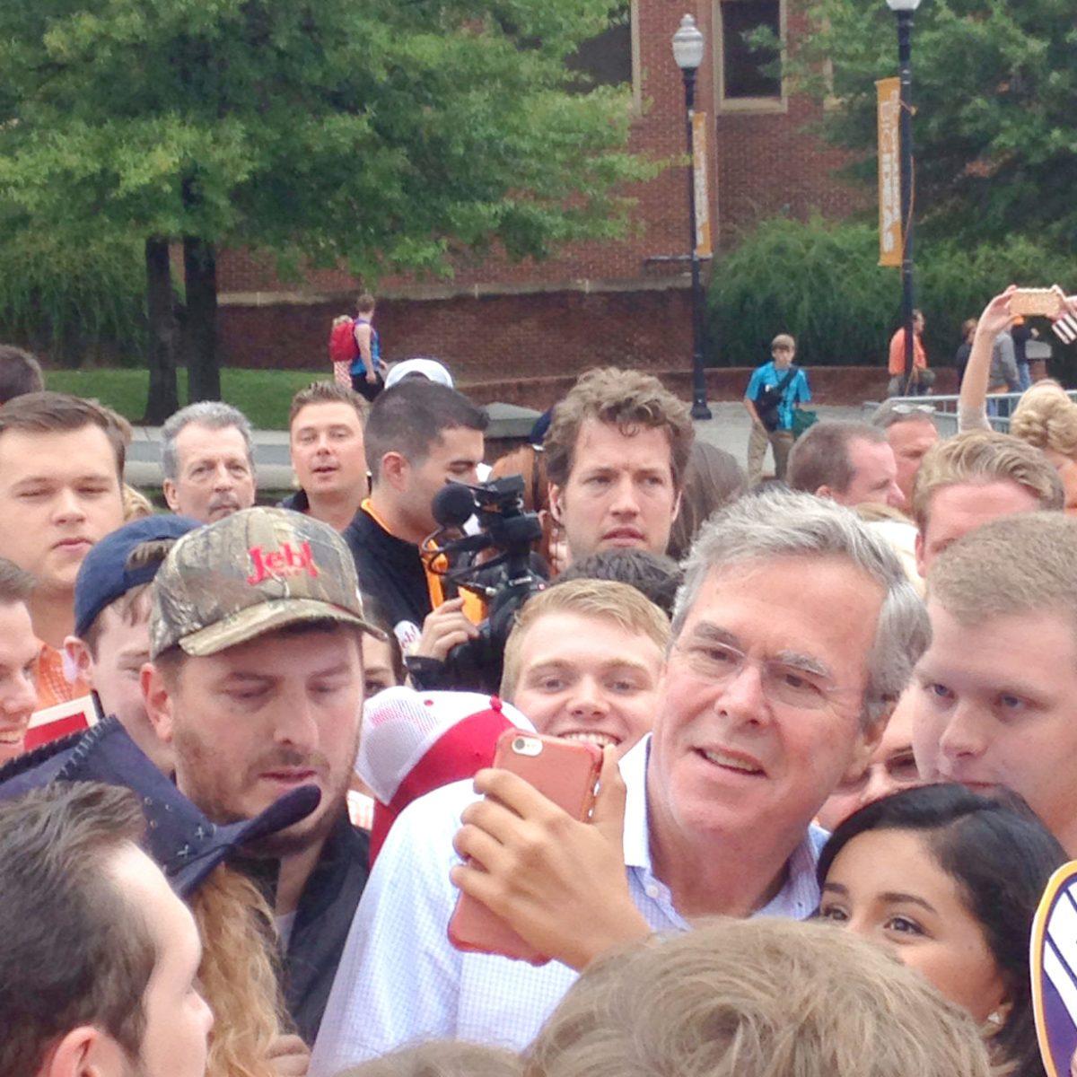 Republican presidential hopeful Jeb Bush takes selfies with students at a tailgate prior to the Tennessee-Georgia game.