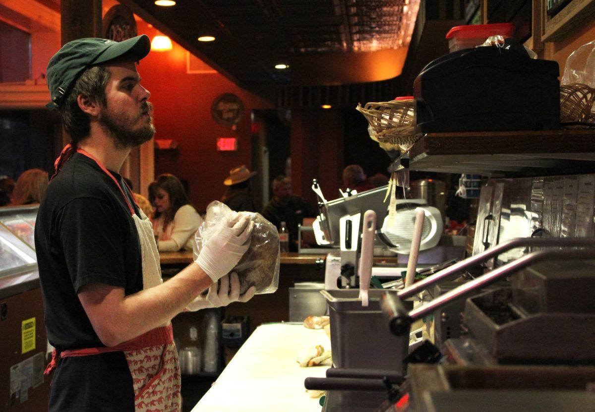 Sandwich artist prepares a reuben sandwich at Market House Cafe.