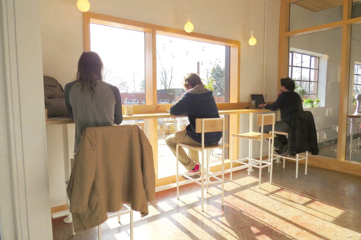 Large picture windows and bar-height counters offer a view of Mid-Mod Collective across the street.