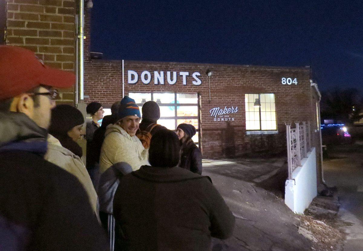 A line extends around the corner in anticipation for the free donuts Makers Donuts gave out to celebrate its grand opening.