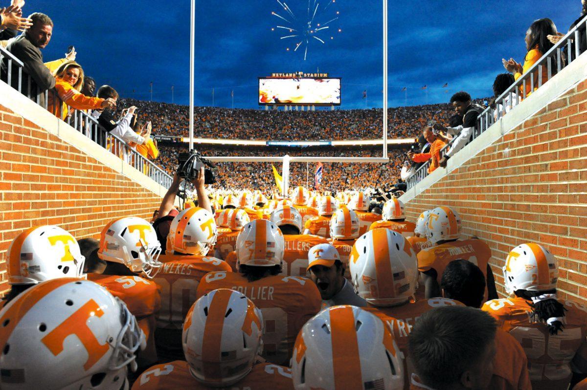 Players spill out of the tunnel on to the field.