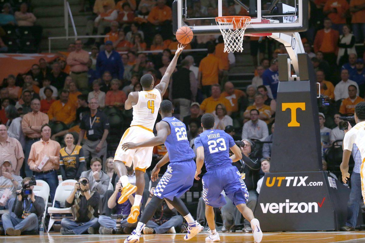 Armani Moore attempts to score against Kentucky defenders.