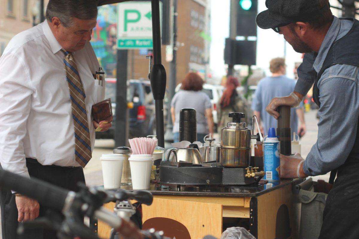 Andrew Mrozkowski serves customers outside of Mast General Store on Gay Street.