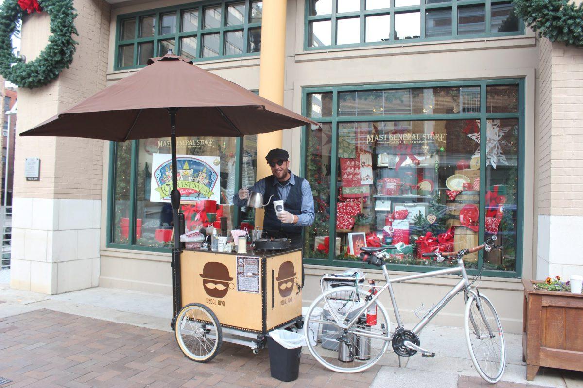 Andrew Mrozkowski serves customers outside of Mast General Store on Gay Street.