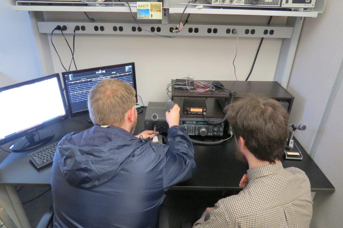 Students Ben Johnson and Mikhail Kravchenko demonstrate how a short-wave radio is operated.