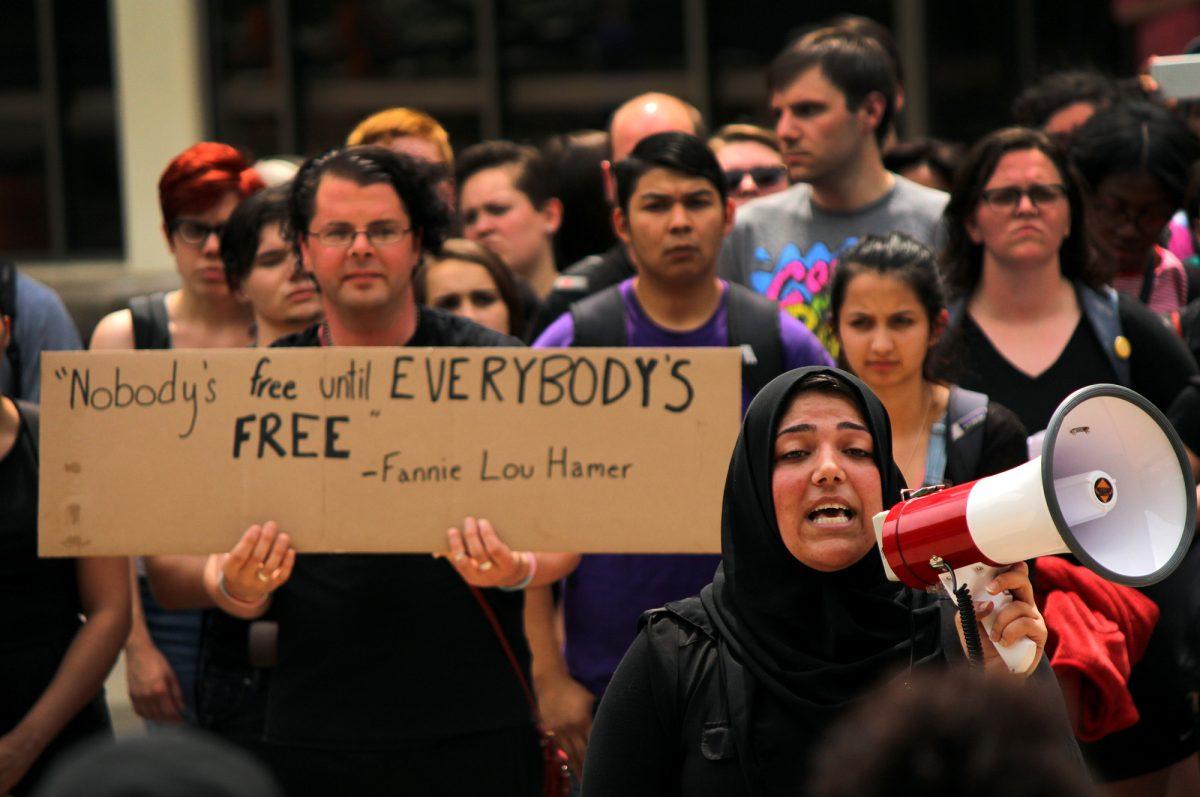 Students, faculty and community members participate in the Mass Class Exit to protest the state legislature redirecting funding from the Office of Diversity on Tuesday, April 19.