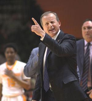 Men's basketball coach, Rick Barnes, instructs plays to the Vols. 