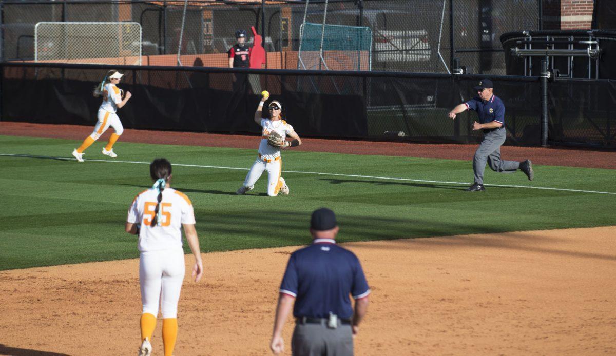 Scarlet McSwain, #3, catches a ball to right for an out and throws to Meghan Gregg, #55, on March 31, 2018.
